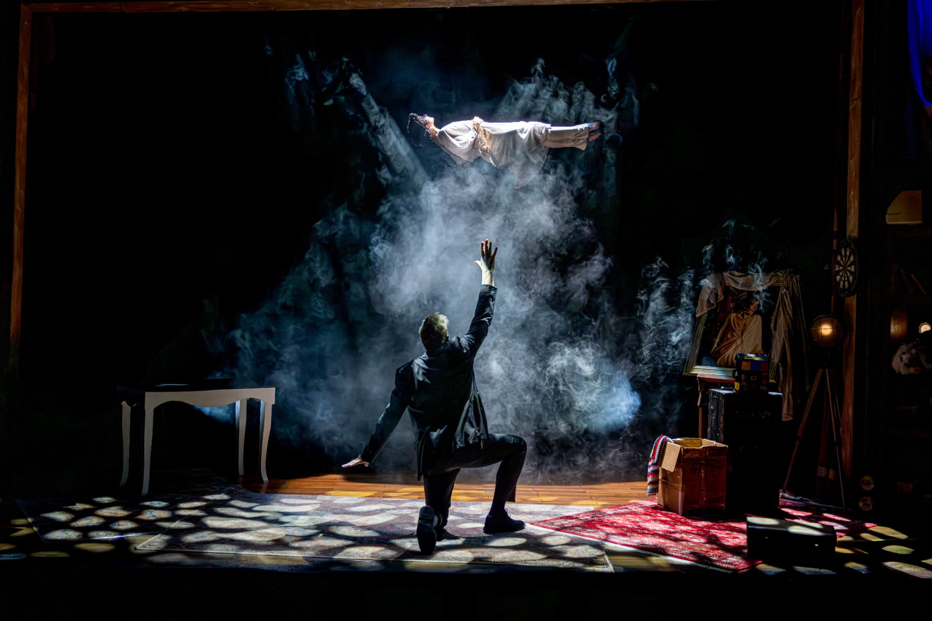 Levitation illusion in a cloud of smoke on stage